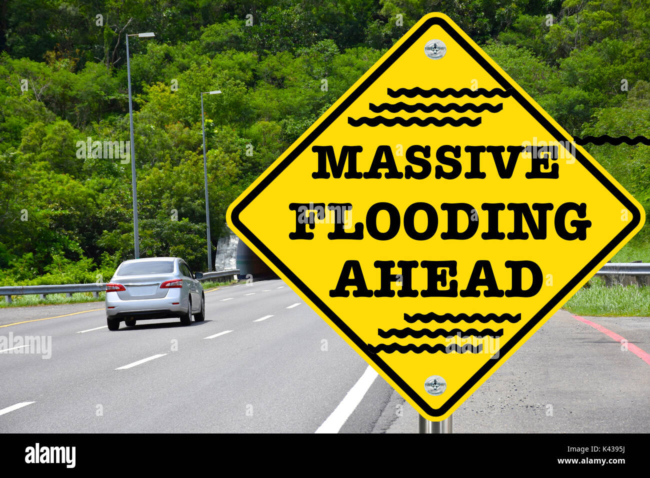Massive Flooding Ahead yellow warning street sign Stock Photo