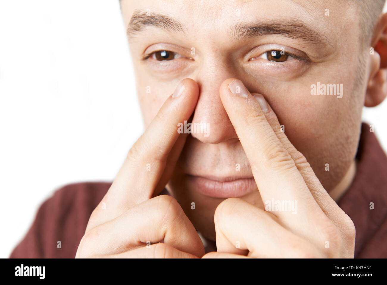 Studio Shot Of Man Suffering With Sinus Problem Stock Photo