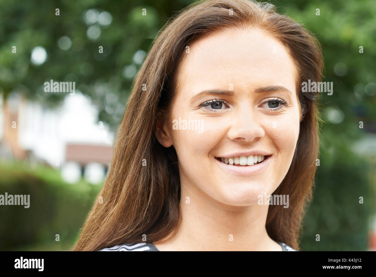 Head And Shoulders Portrait Of Smiling Teenage Girl Stock Photo Alamy