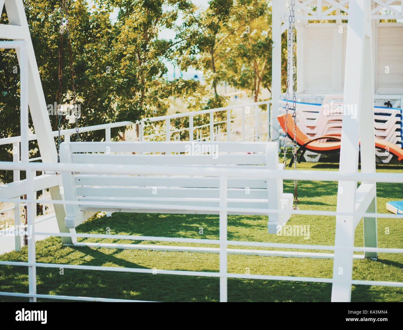 White Wooden Swinging Bench In Back Yard Stock Photo 157434064