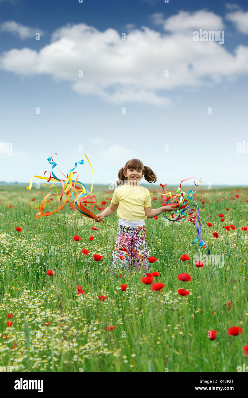 happy little girl playing on meadow spring season Stock Photo - Alamy