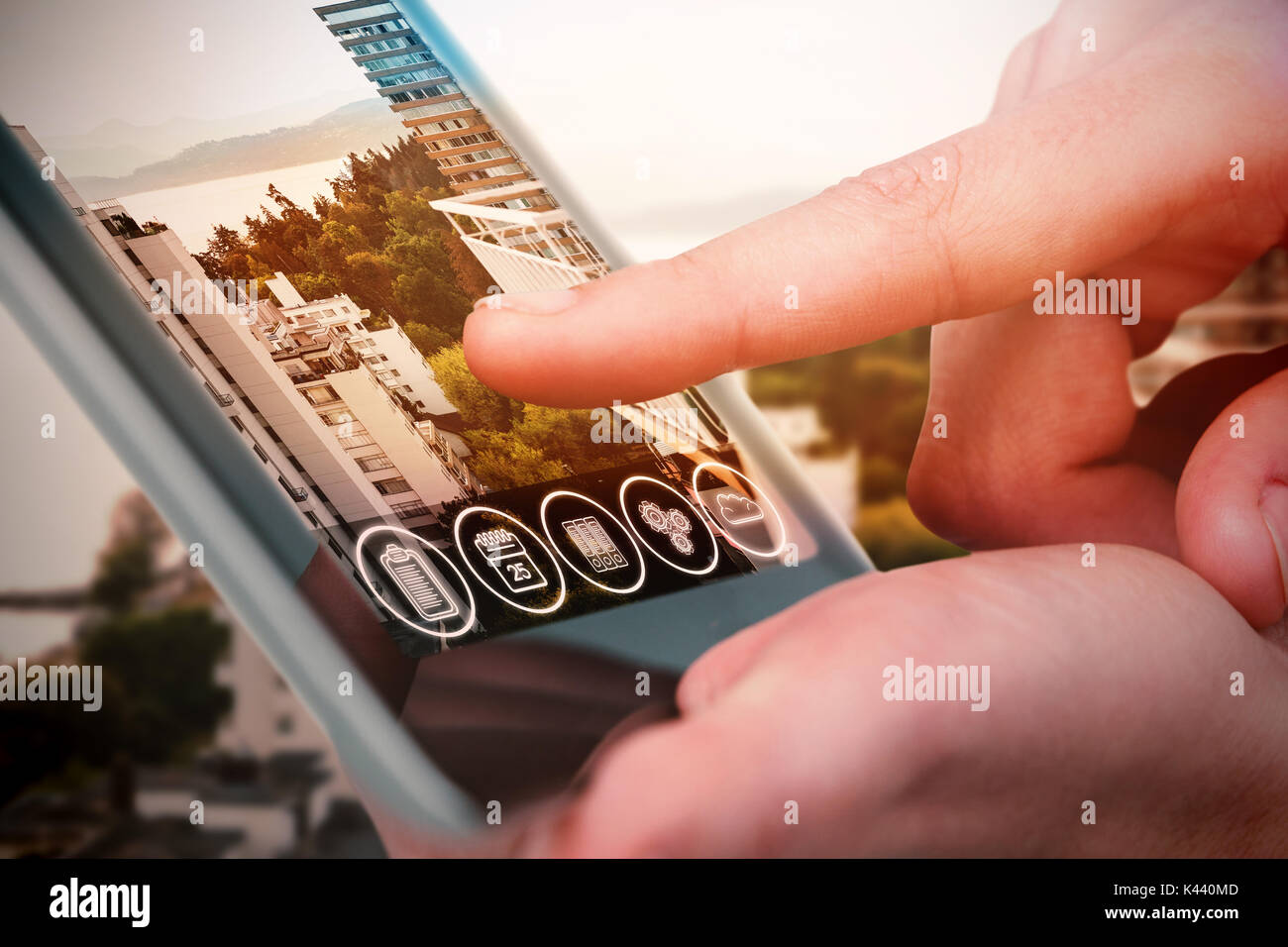 Hands using tablet on white background against white buildings by sea Stock Photo