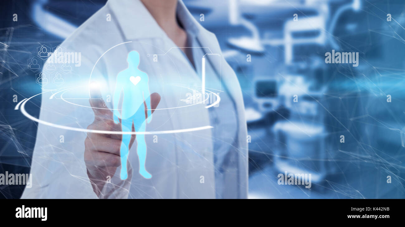 Midsection of female doctor using digital screen against empty operation room Stock Photo
