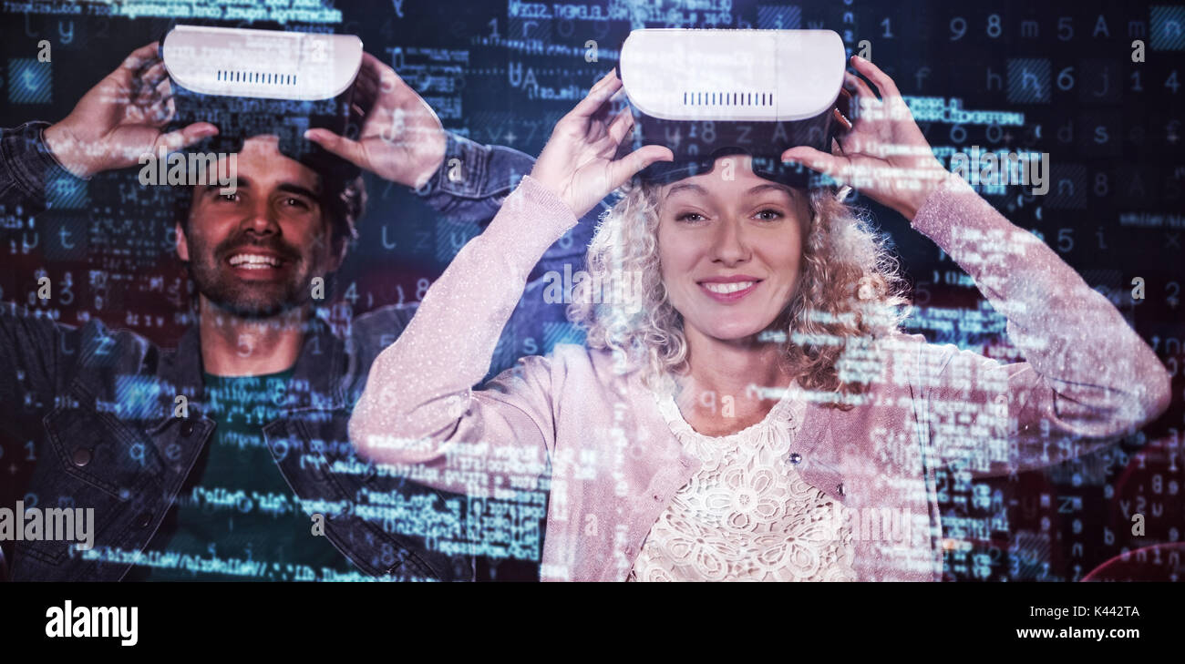 Image of data against couple using virtual reality headset Stock Photo