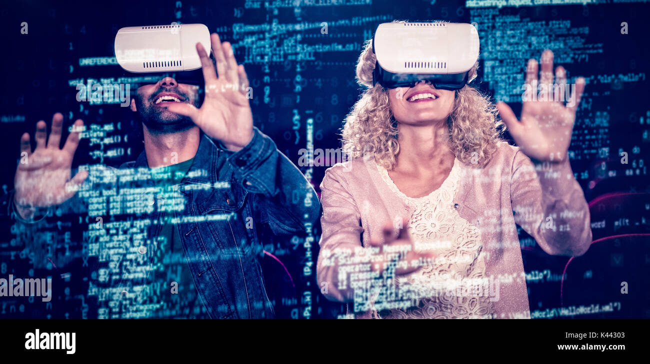 Image of data against couple using virtual reality headset Stock Photo