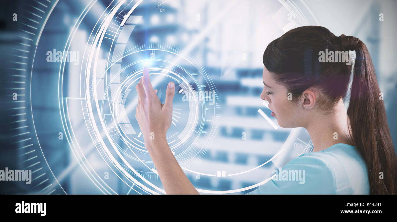 Young woman using imaginative digital screen against circle interface with percentage in blue background Stock Photo