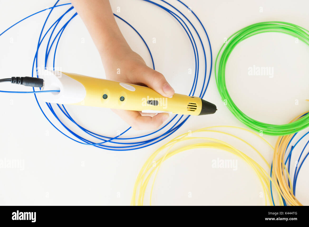 Kid's hands with 3D printing pen Stock Photo - Alamy