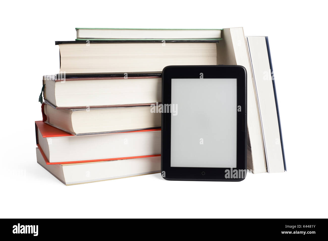 Stacked books and ebook device with blank screen, isolated on white. The e-book device is a dedicated device for reading e-books. Stock Photo