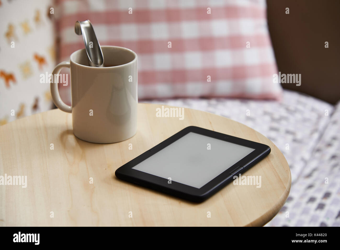 ebook device with blank screen on a table. The e-book device is a dedicated device for reading e-books. Stock Photo
