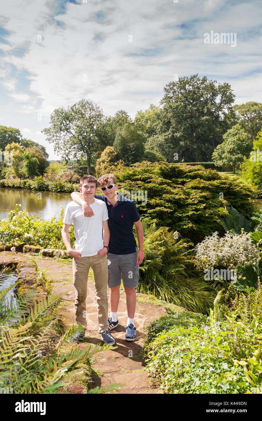 Two teenage brothers beside the lake at Sandringham House at Sandringham Estate in Norfolk , England , Britain , Uk Stock Photo