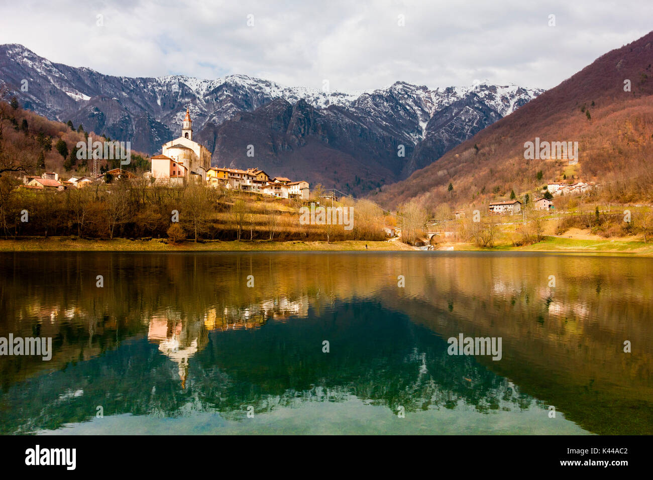 Laghi, Province of Vicenza, Veneto, Italy. Reflections of a church in a lake. Stock Photo