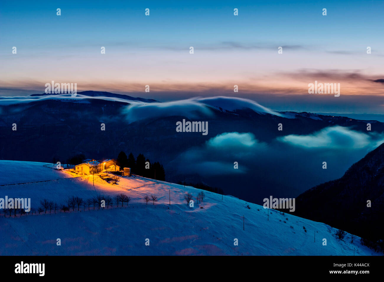 Ecchelen, Stoccareddo, Altopiano of Asiago, Province of Vicenza, Veneto, Italy. Small hamlet on hill at dawn. Stock Photo