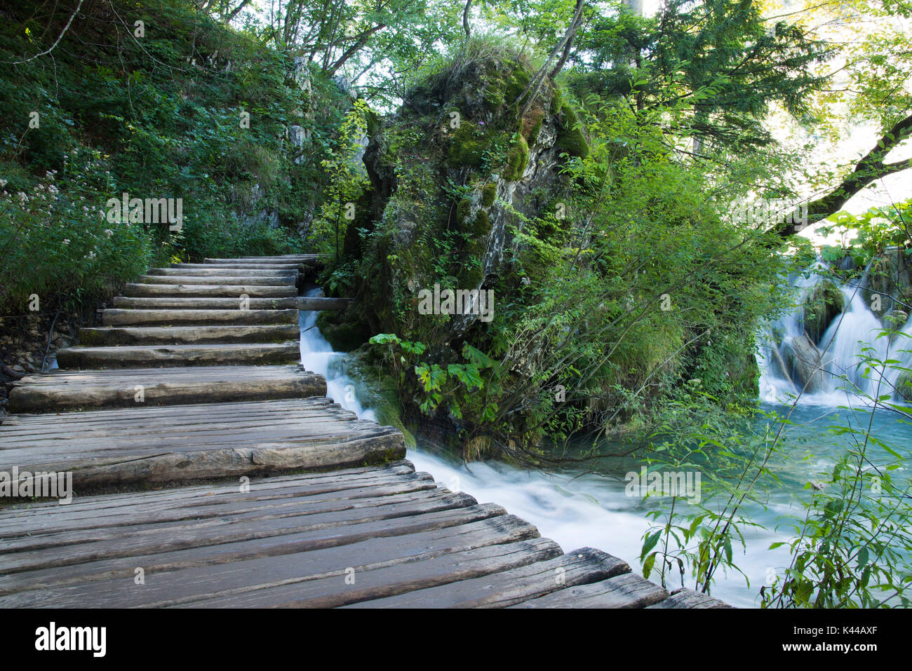 Path along the Plitvice National Park, Plitvicka Jezera Lakes, Croatia with little falls nearby. Stock Photo