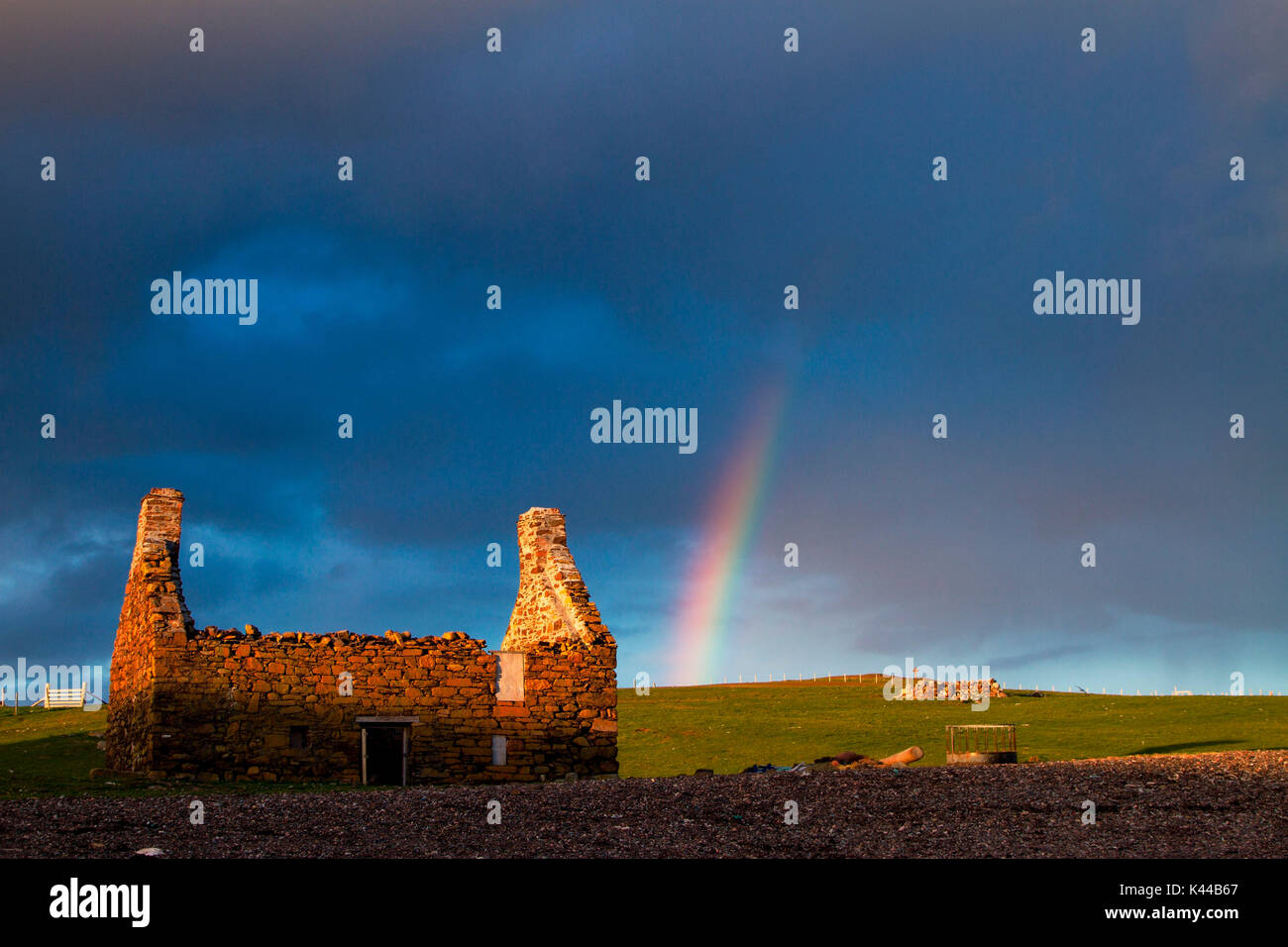 Shetland, Scotland. Sunset with rainbow on an old fisherman's house at the beach of Stenness in the Shetland Islands, Scotland Stock Photo