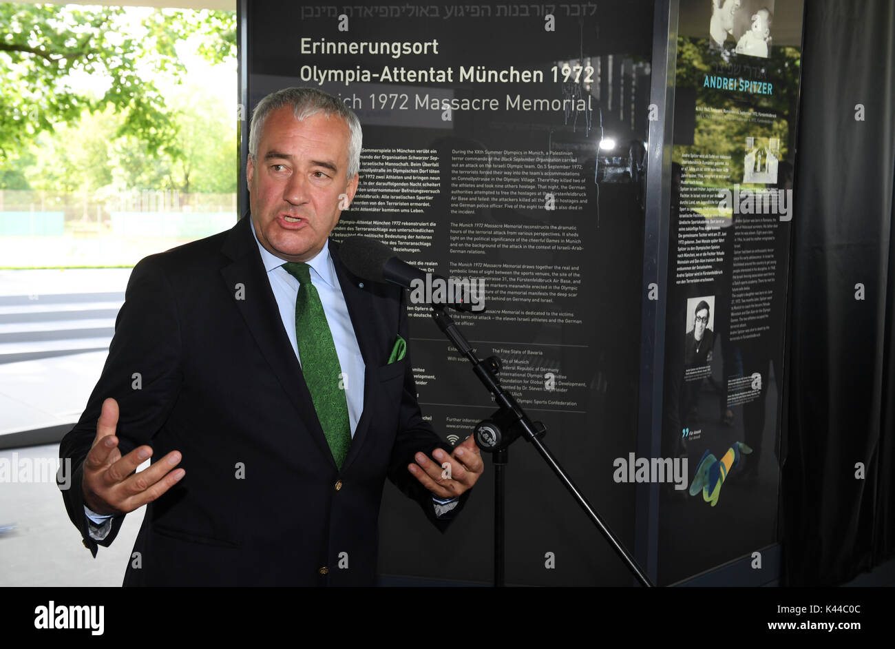 Munich, Germany. 4th Sep, 2017. Ludwig Spaenle, Minister of Education in Bavaria (CSU), explains an information board at the memorial site for the 1972 Munich massacre of the Israeli Olympic team in Munich, Germany, 4 September 2017. The memorial site at the western Linden hill remembers the victims of the Palestinian attackers that killed eleven members of the Israeli Olympic team during the Summer Olympics 1972 in Munich, the capital of Bavaria. Photo: Felix Hörhager/dpa/Alamy Live News Stock Photo
