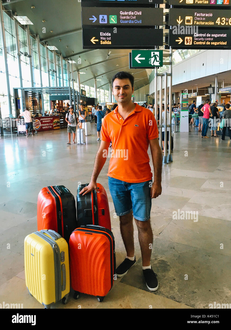 VALENCIA, SPAIN - AUGUST 06, 2016: Man With Many Luggage Bags Is Waiting For Airplane In Airport Terminal. Stock Photo