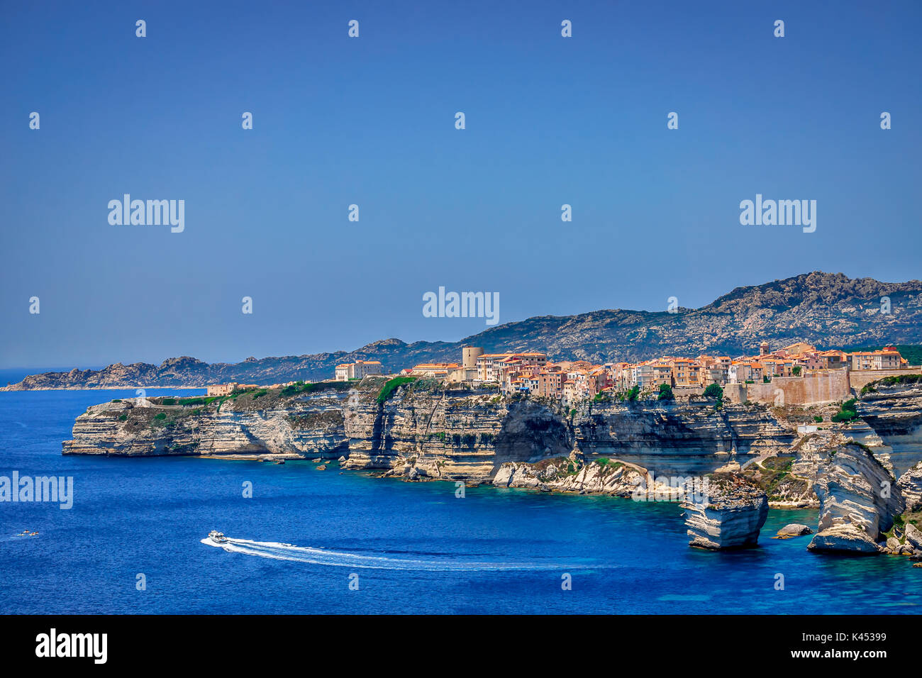 A view on the spectecular cliffs and the town of Bonifacio in Corsica, France with the ocean in the foreground Stock Photo