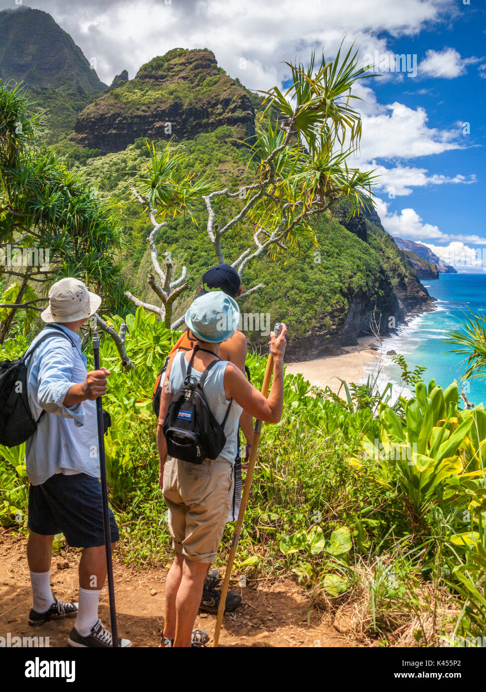 Hikers on the Kalalau Trail on Kauai see Hanakapiai Beach and the Na Pali Coast Stock Photo