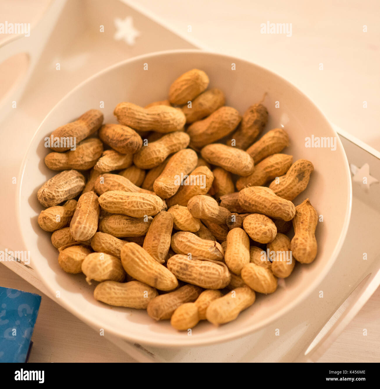 Peanuts to crack in a bowl on the table Stock Photo