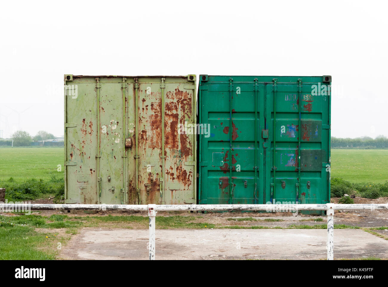 Ageing Green Coloured Rusting Storage Containers Located in a Field with an Overcast Background, Large Container, Secure Storage, Green Rusted Metal Stock Photo