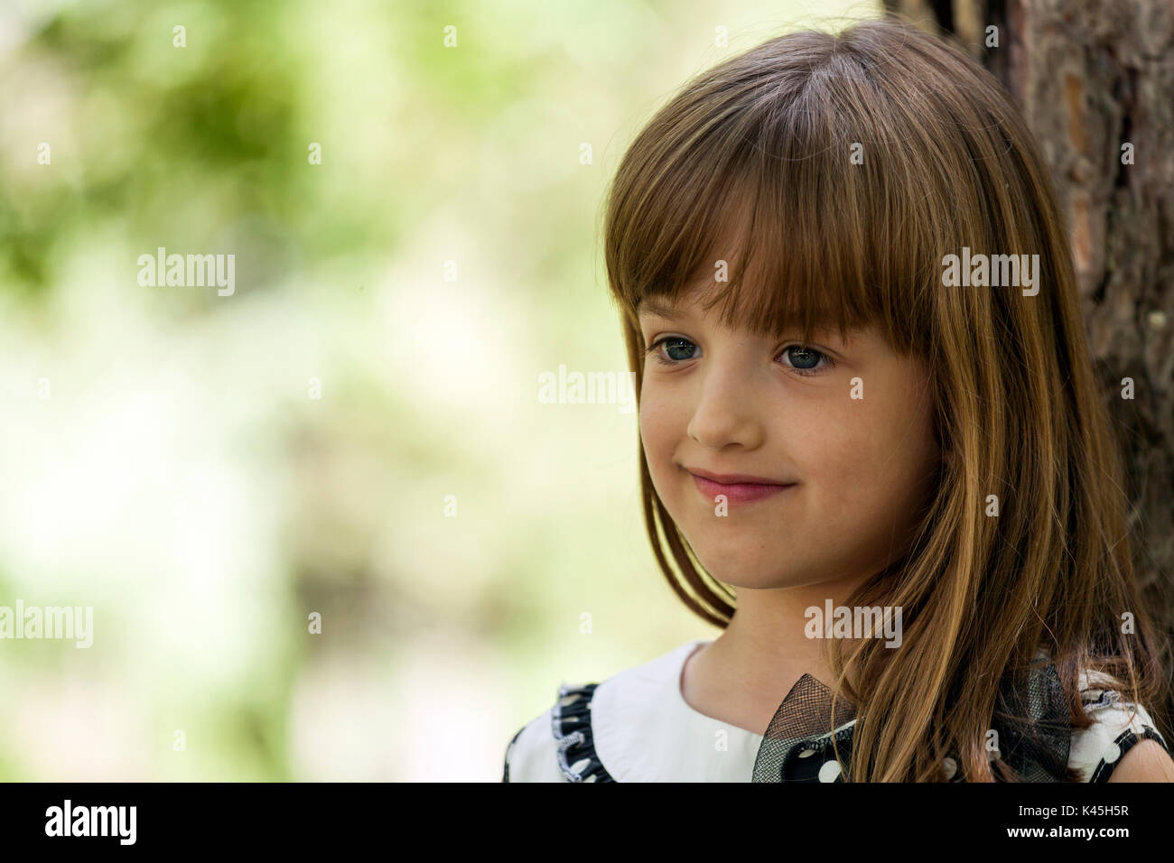 Close up portrait of a beautiful little girl with big blue eyes in the ...