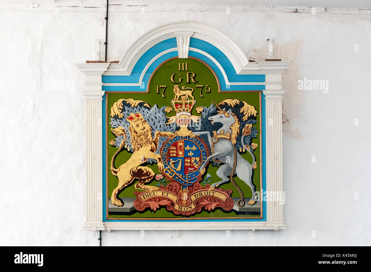 The Royal Arms of George III on the wall of St George's church, Ivychurch on Romney Marsh, Kent. Stock Photo