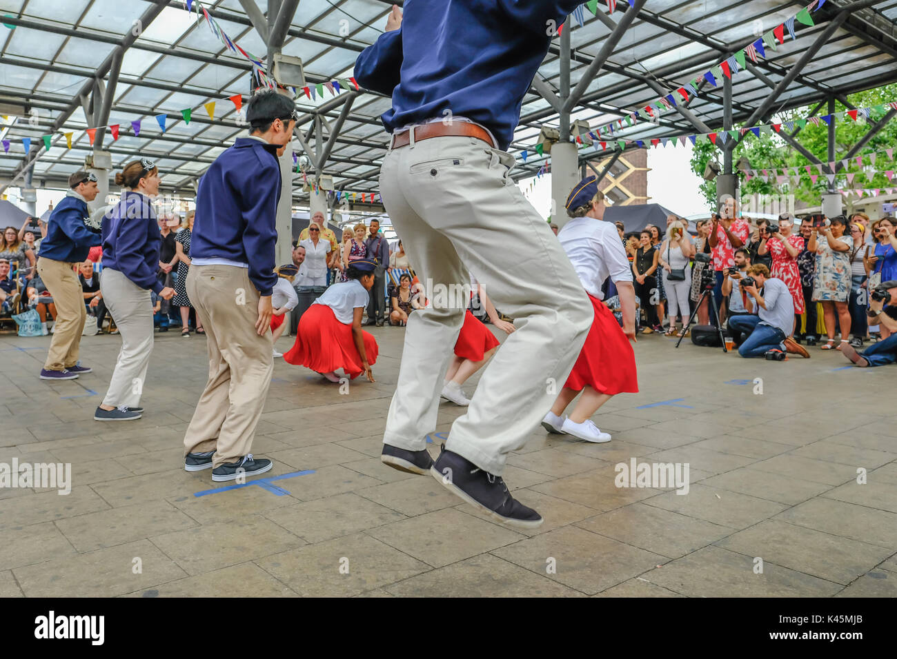 Chrisp Street, London, UK - July 16, 2017: Energetic dance demonstration at Swing East music festival in Chrisp Street Market.  Crowds of spectators w Stock Photo