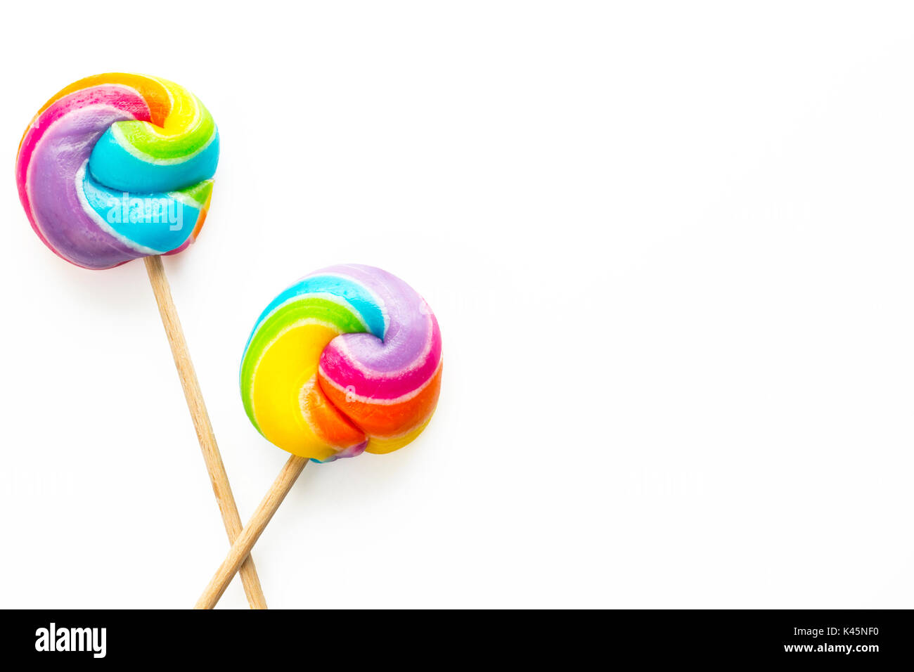 rainbow lollipop on color background Stock Photo - Alamy