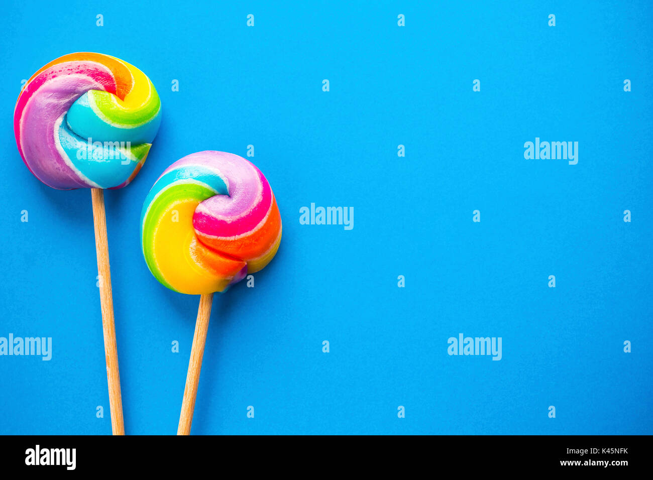 rainbow lollipop on color background Stock Photo - Alamy