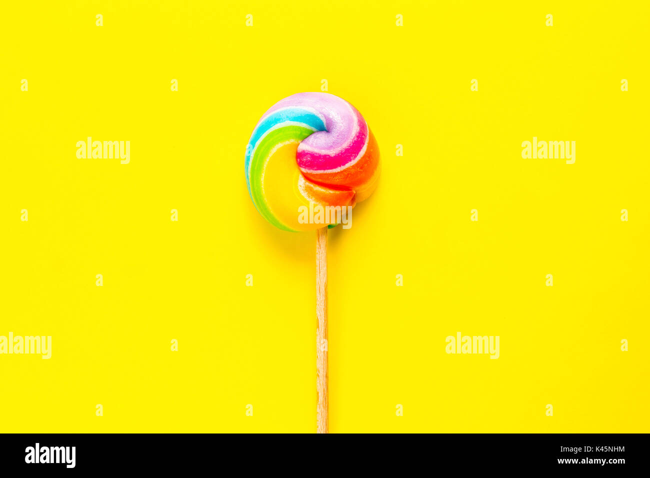 rainbow lollipop on color background Stock Photo - Alamy