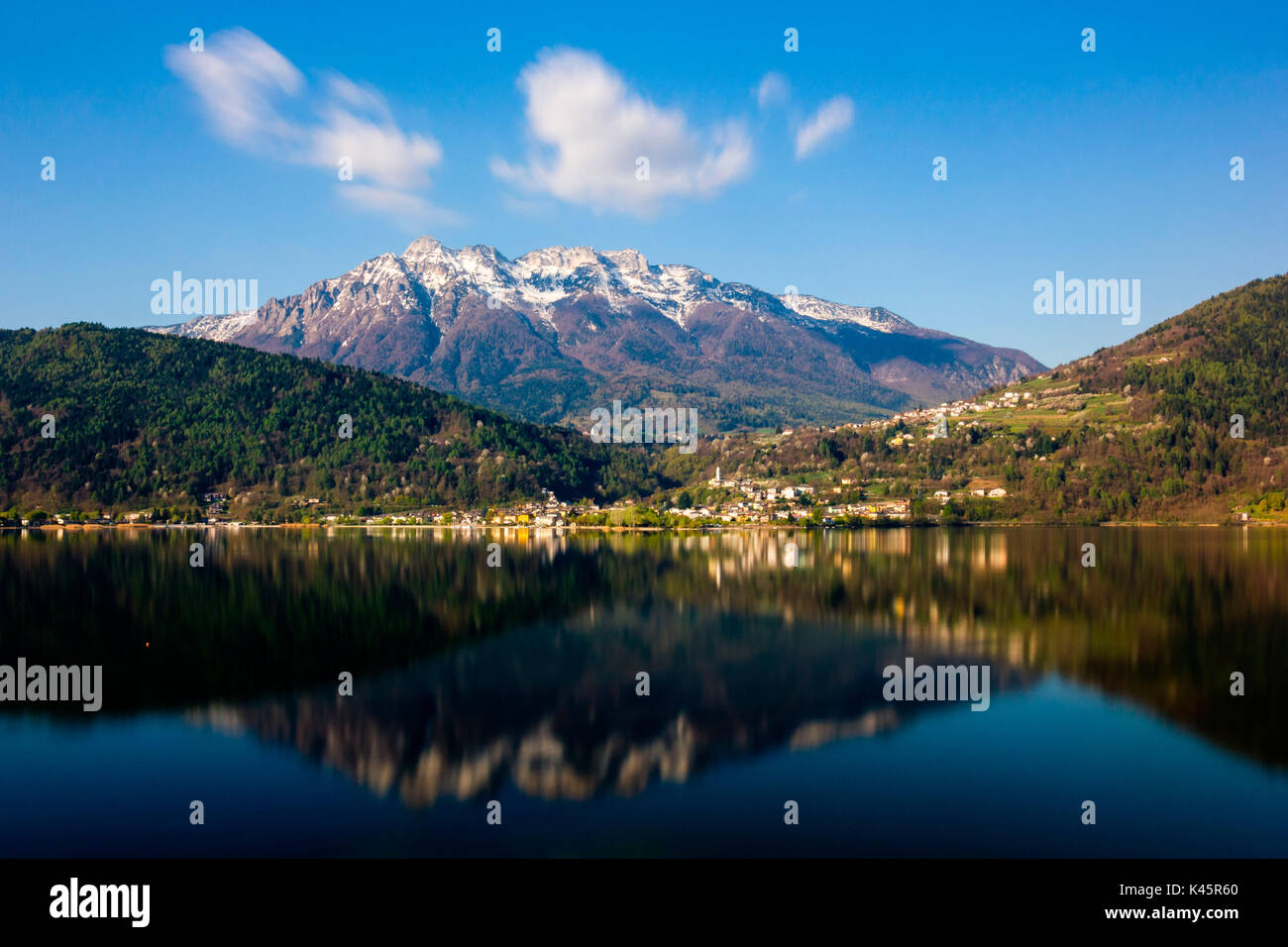 Reflections, Lake Caldonazzo, Province of Trento, Trentino Alto Adige, Italy. Small town on waters edge. Stock Photo