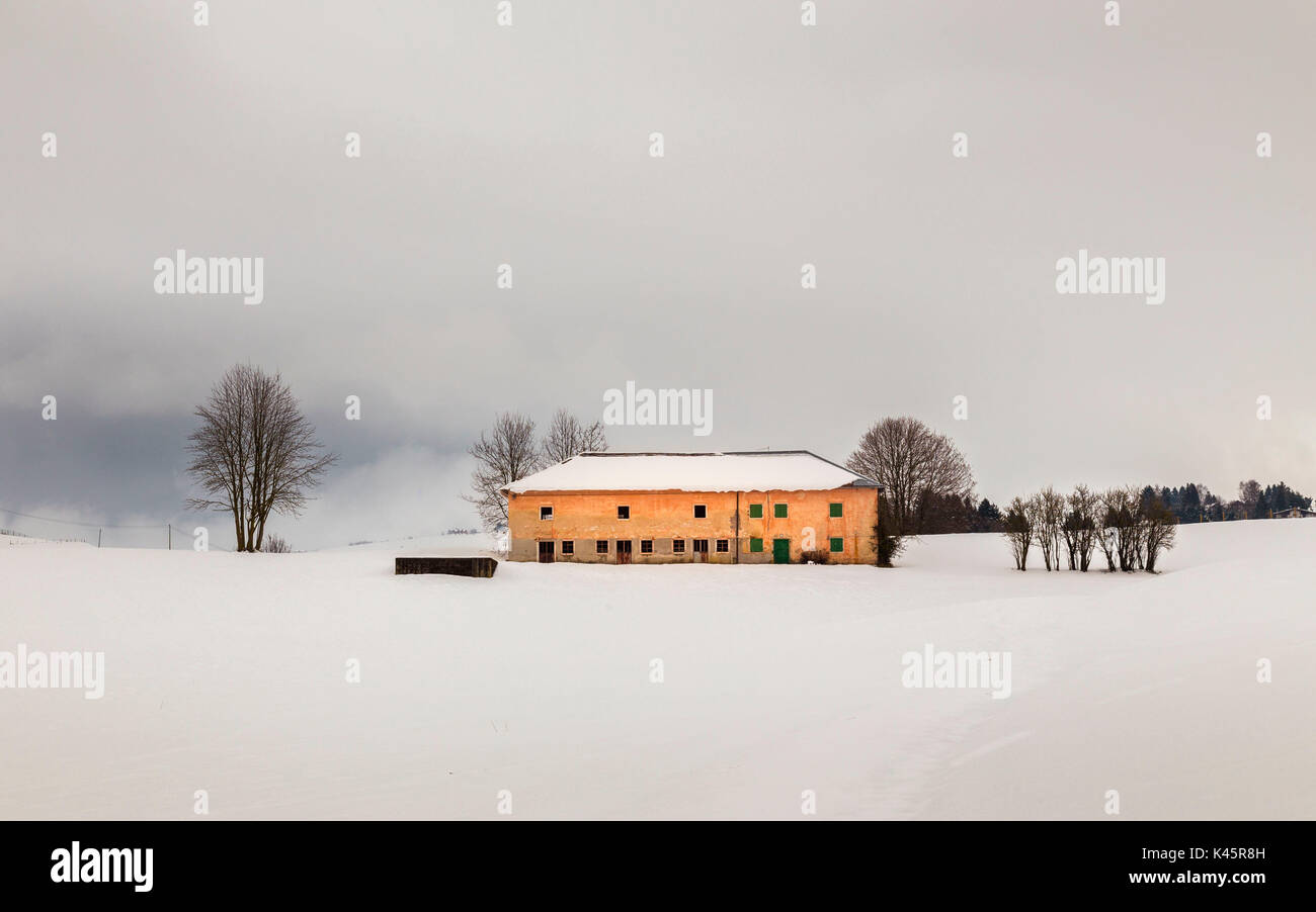 Barn, Altopiano of Asiago, Province of Vicenza, Veneto, Italy. Typical farmhouse and snow in the country. Stock Photo