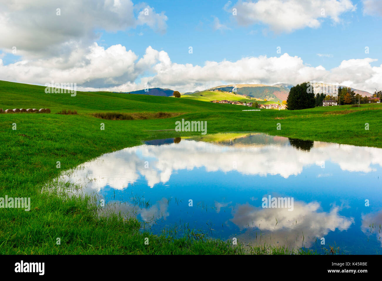 Lake, Altopiano of Asiago, Province of Vicenza, Veneto, Italy. Small spring lake in field. Stock Photo