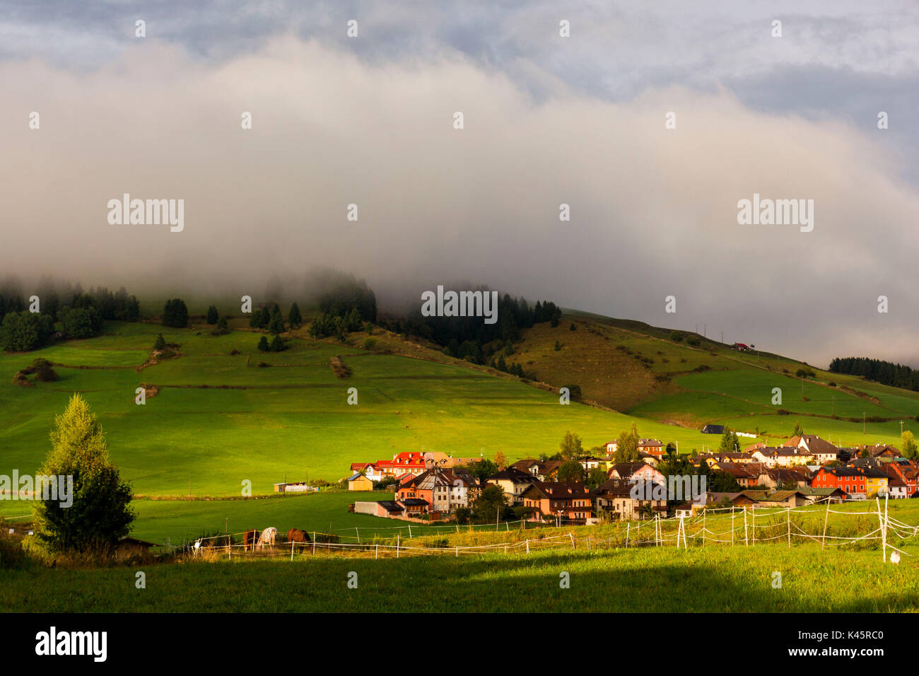 Residential area, Altopiano of Asiago, Province of Vicenza, Veneto, Italy. Country houses with horse paddocks. Stock Photo