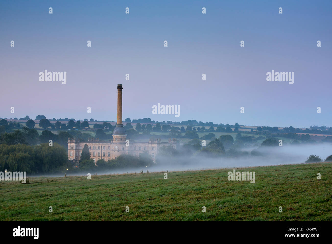 Early morning mist before sunrise over Bliss Tweed Mill. Chipping Norton, Oxfordshire, England Stock Photo