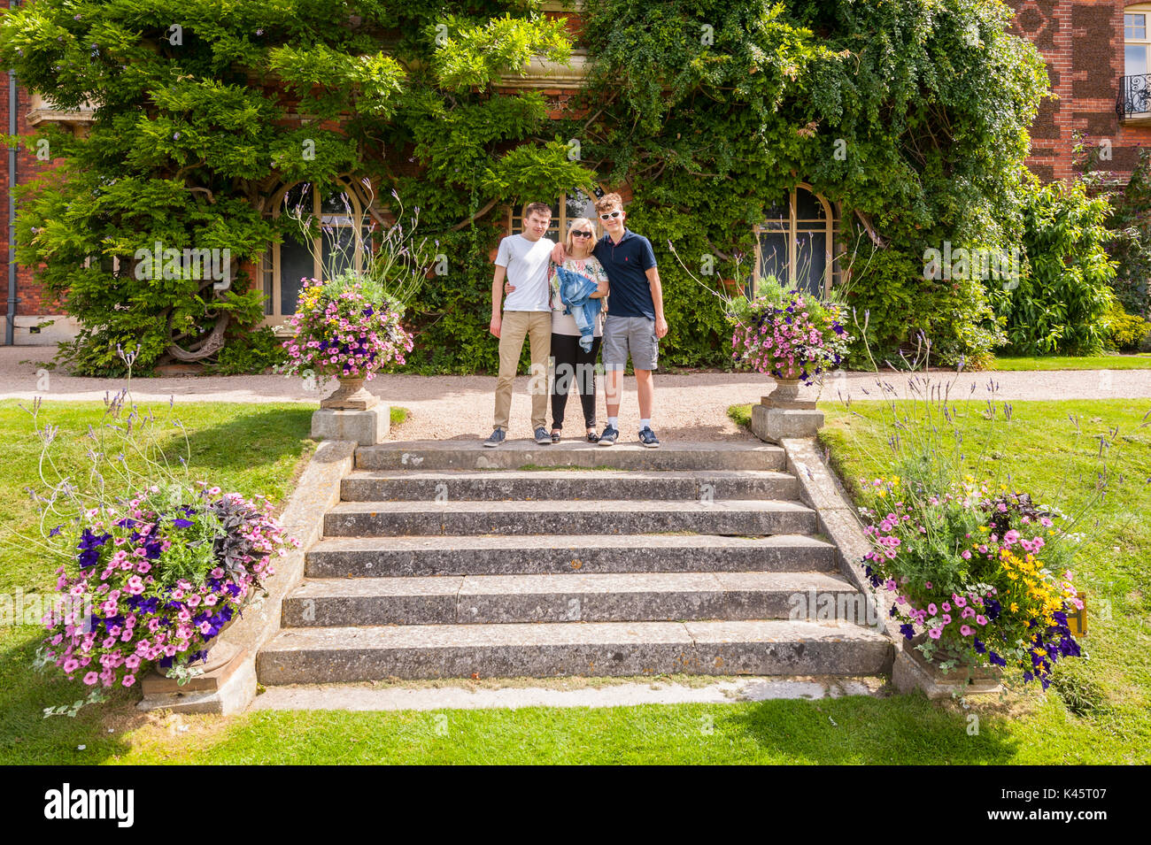 A mother and her 2 sons pose for a photo at Sandringham House at