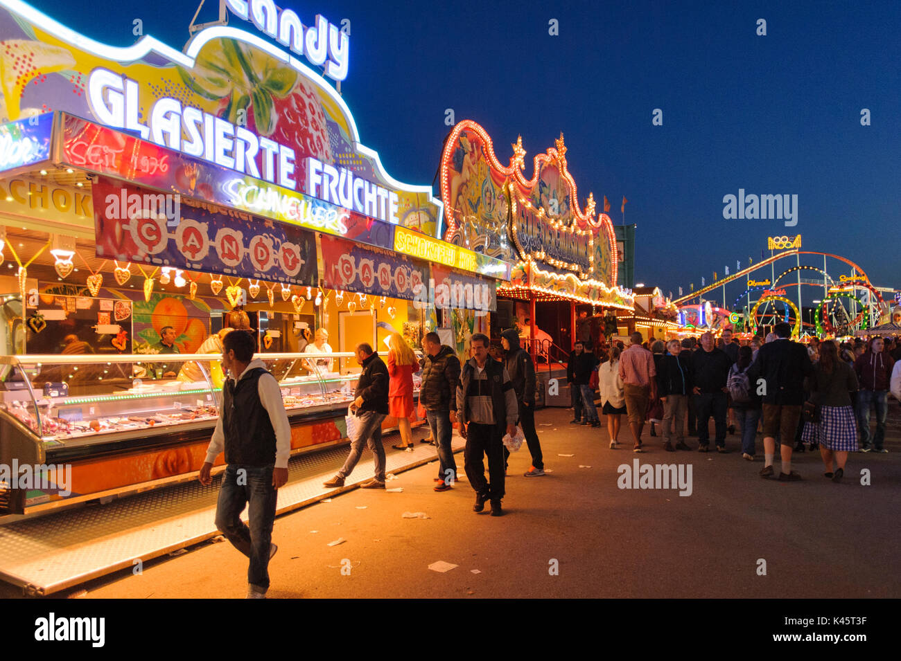 Oktoberfest in Munich is the biggest beer festival of the world with many huge beer tents, carousels, and amusement huts Stock Photo