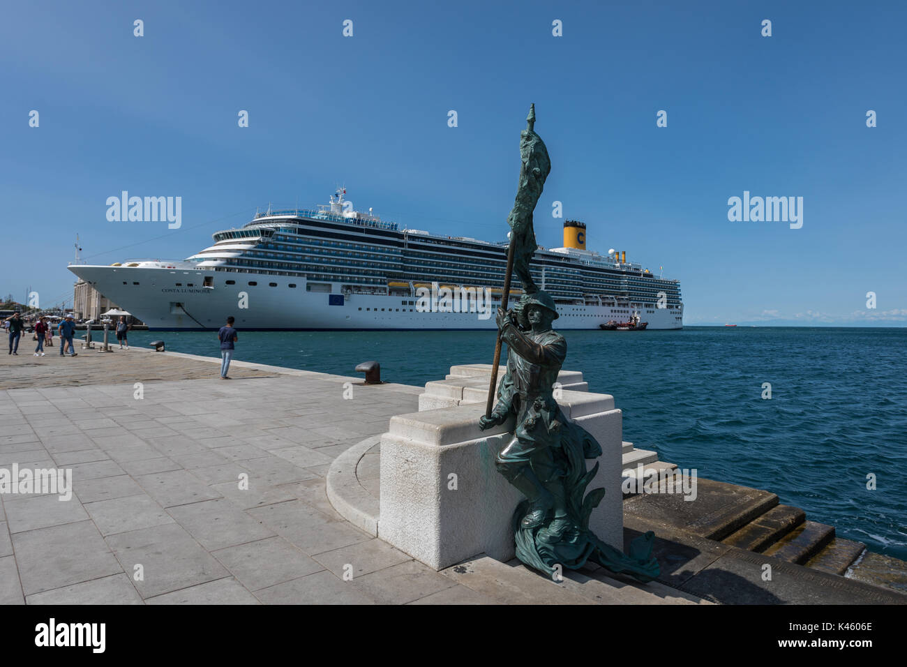 Statue of Bersaglieri soldier in Trieste, Italy with the Costa Luminosa luxury cruise ship in the background Stock Photo