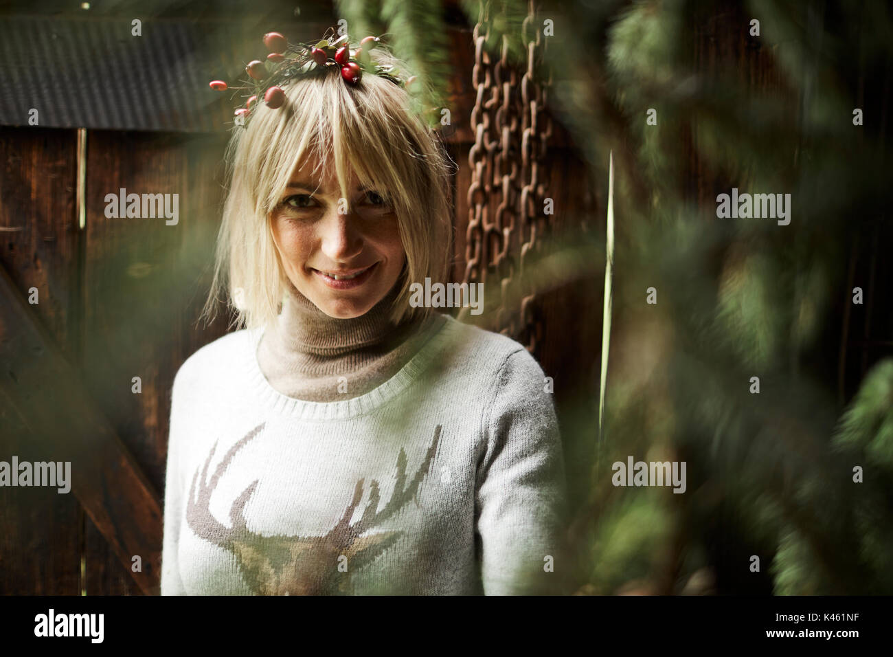 Blond woman, headdress, garland with rose hips, twigs of evergreens for decoration, portrait, Stock Photo
