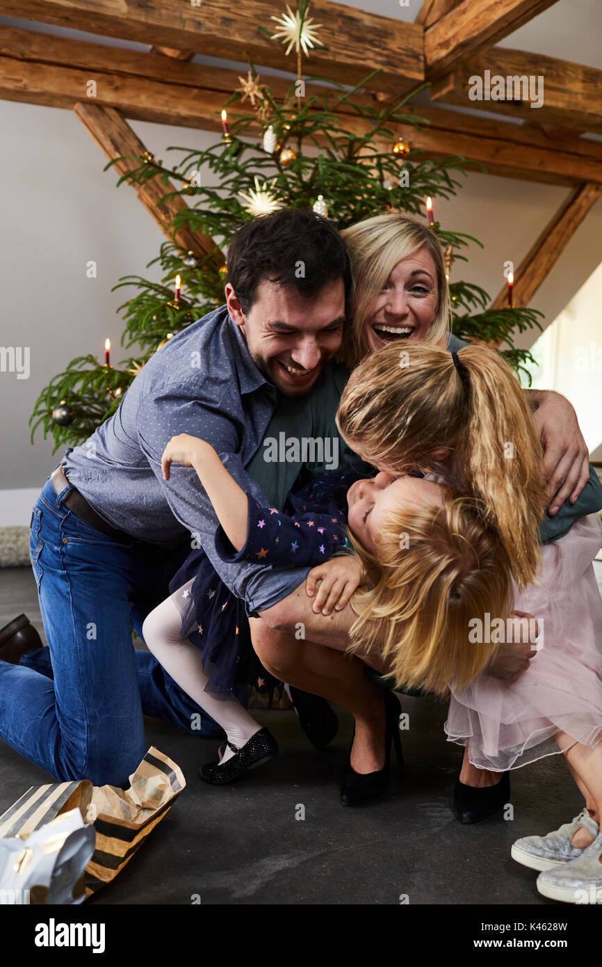 Family with children in front of Christmas tree, Christmas Eve Stock Photo