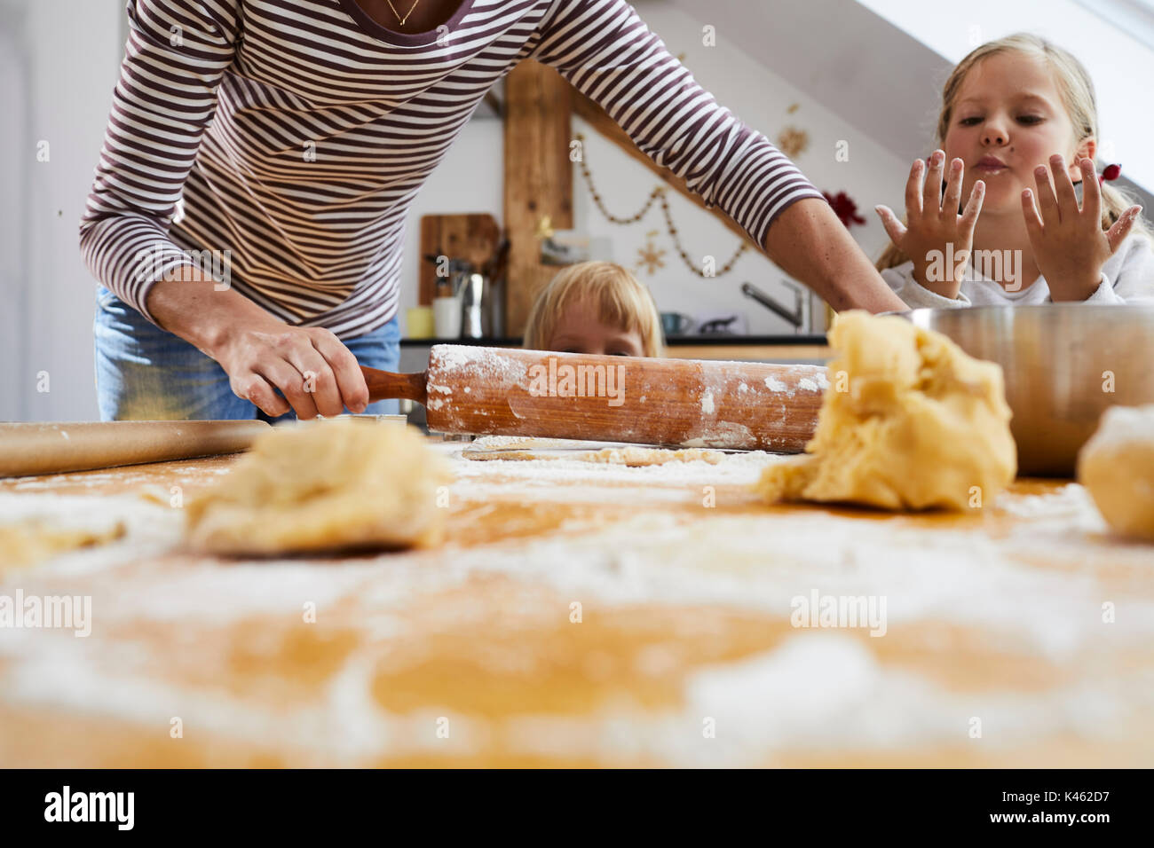 Mother and daughters baking christmas cookies, roll out dough, detail, Stock Photo