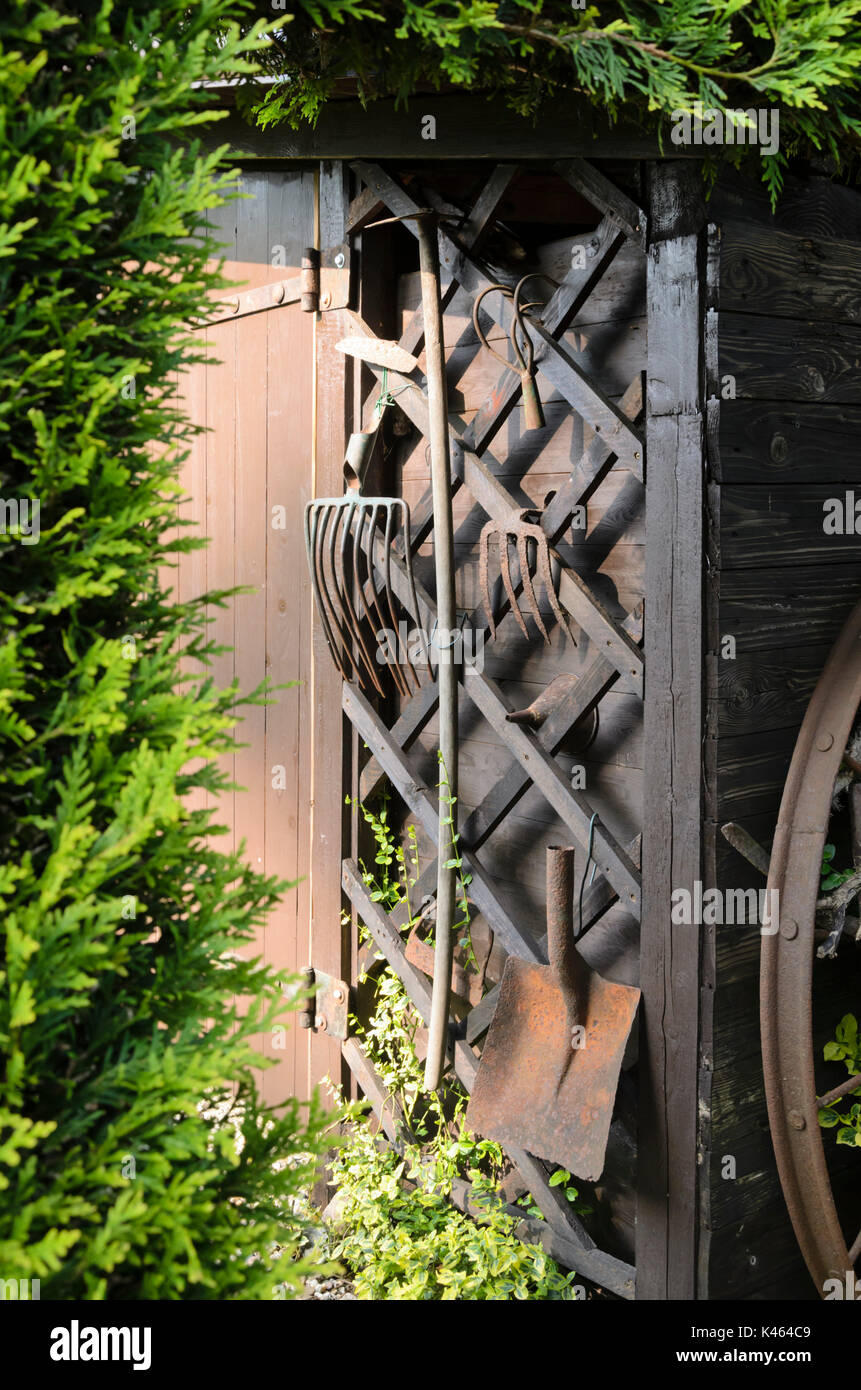 Old gardening tools on a wall. Design: Marianne and Detlef Lüdke Stock Photo