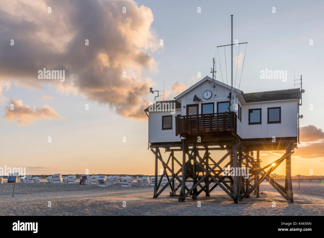 Wooden house on stilts on the beach at sunrise Stock Photo