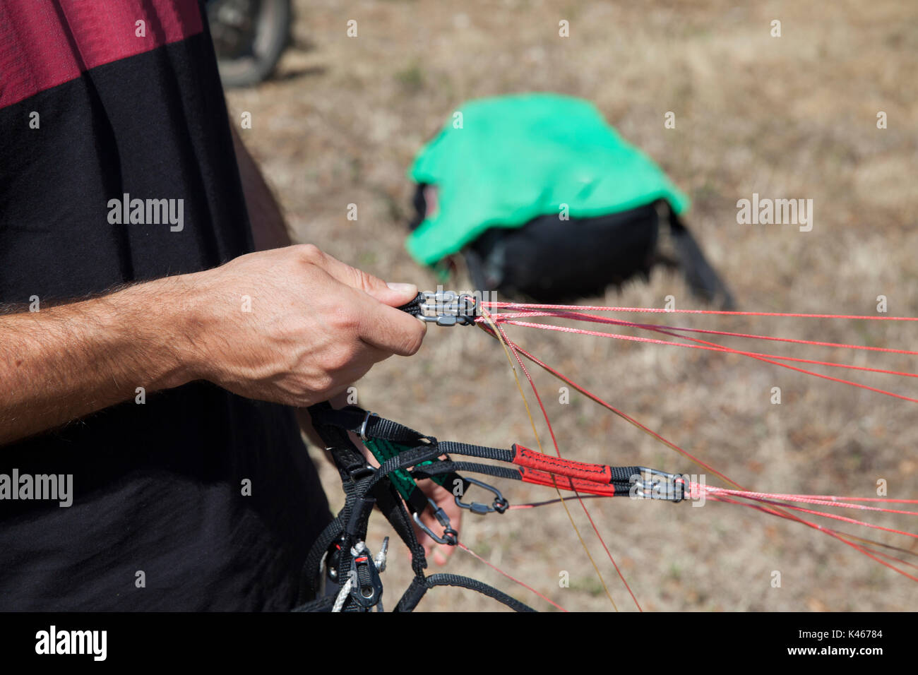 pilot checks his paraglider before takeoff Stock Photo Alamy