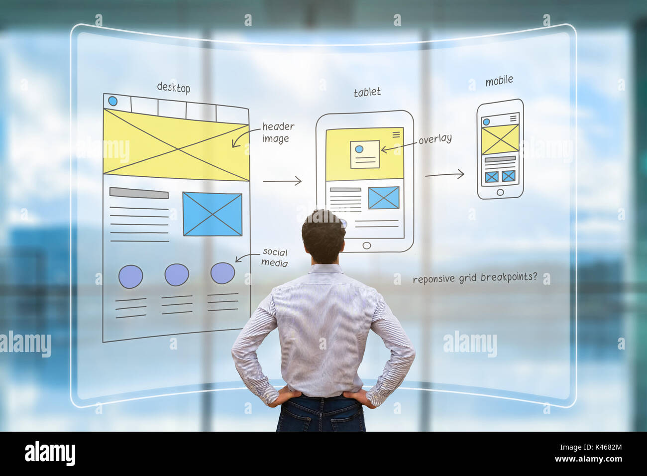 Website development UI/UX front end designer reviewing sketched wireframe layout design mockup for responsive web content with AR screen Stock Photo