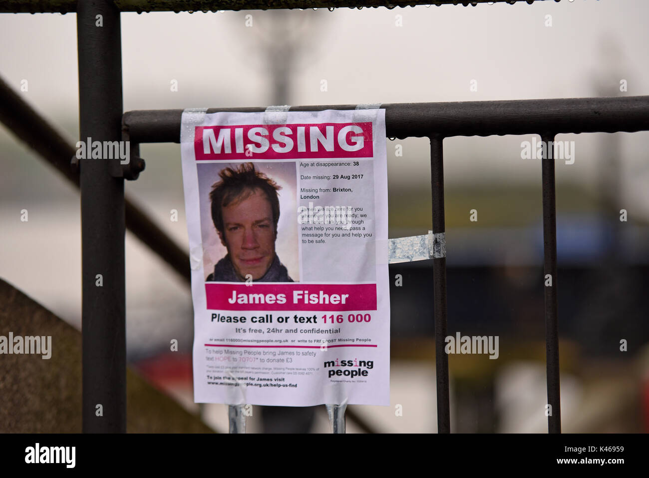 Missing people poster for James Fisher taped to a fence. Rain drops. London, UK. Space for copy Stock Photo
