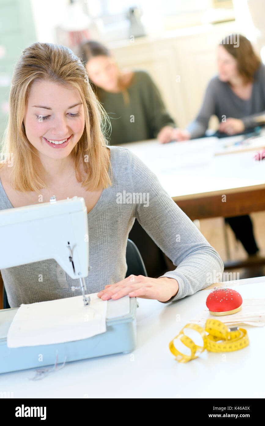 female tailor with sewing machine and sews fabric Stock Photo Alamy