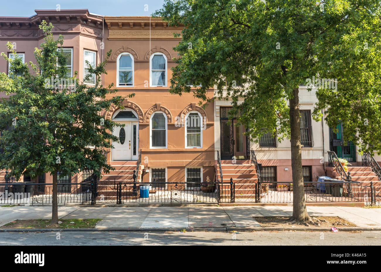 A row of multi-colored brick apartment buildings on St. John Place in the Crown Heights Neighborhood of Brooklyn, New York Stock Photo