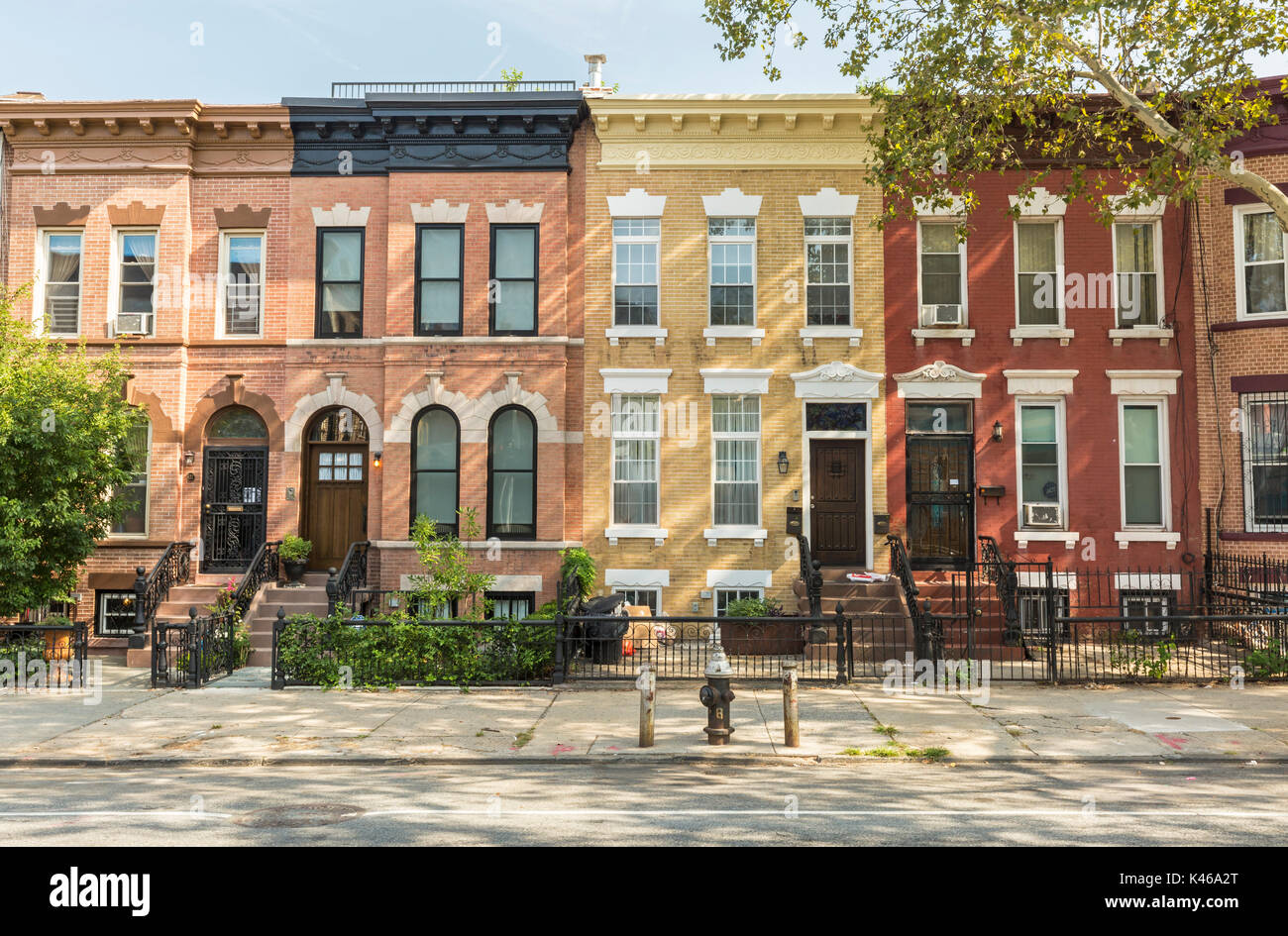 A row of multi-colored brick apartment buildings on St. John Placein the Crown Heights Neighborhood of Brooklyn, New York Stock Photo
