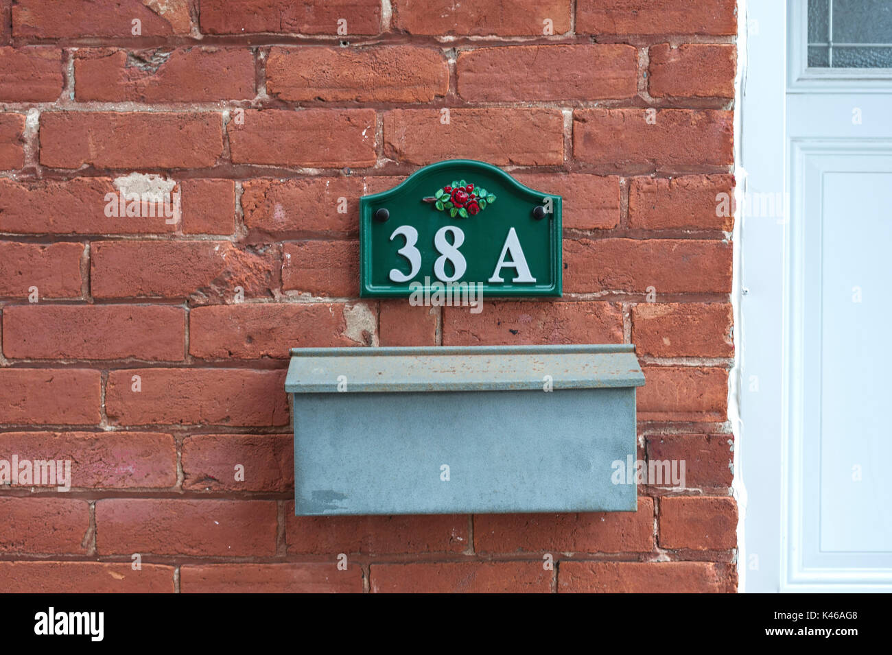 vintage mailbox and number on brick wall Stock Photo Alamy